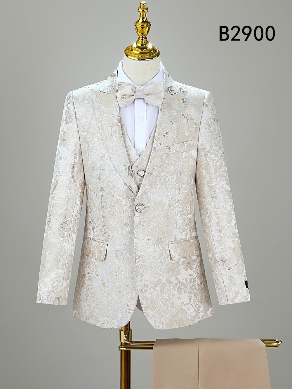 The Unique Design Menswear BOY SUIT 5-PC SET B2900, a cream floral boys’ formal suit with matching bow tie, is displayed on a mannequin. "B2900" is shown in the top right corner.