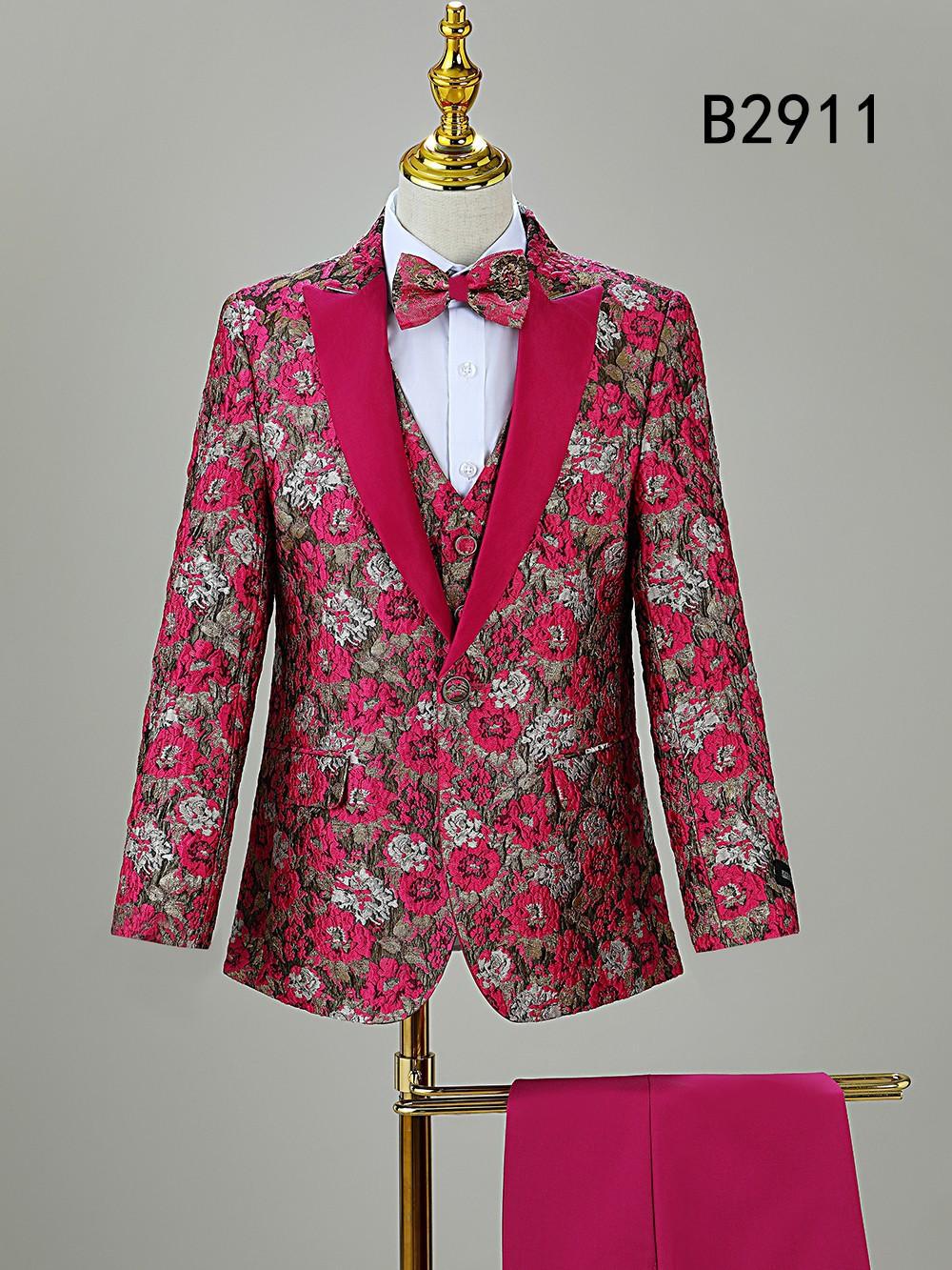 A red and pink floral 5-piece boy suit set (BOY SUIT 5-PC SET B2911) by Unique Design Menswear, includes matching bow tie and vest, displayed on a gold-stand mannequin. "B2911" in black text at top right—ideal for boys' formal wear.
