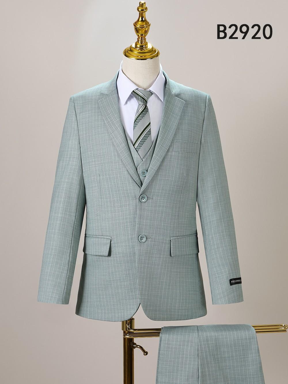 The Unique Design Menswear BOY SUIT 5-PC SET B2920 is shown in light green with a subtle check pattern, styled on a mannequin with a white shirt and striped tie, and matching trousers displayed nearby.