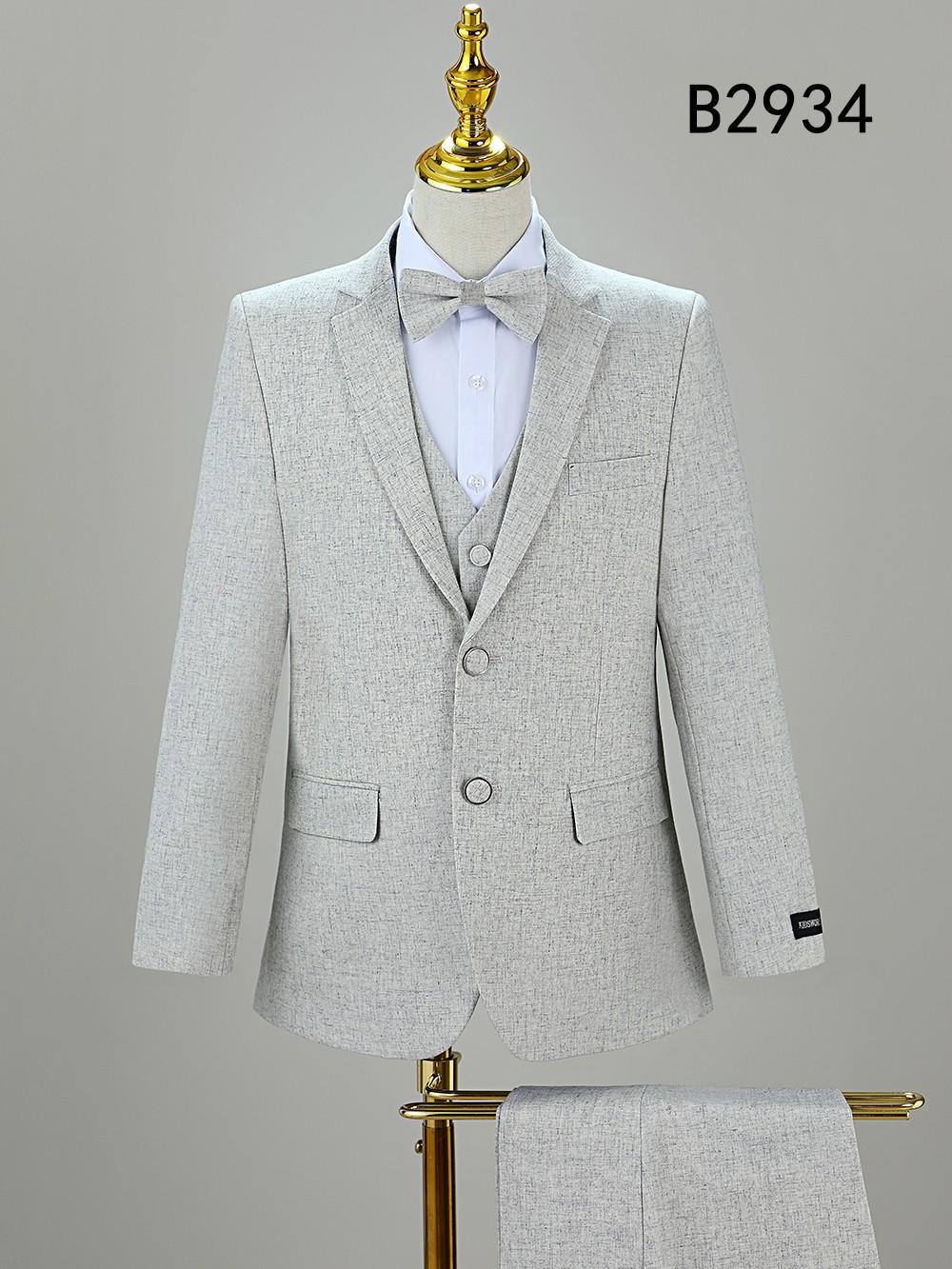 A light gray BOY SUIT 5-PC SET B2934 by Unique Design Menswear is displayed on a mannequin with a bow tie, matching fabric draped over a stand, and model number B2934 shown in the top right corner.