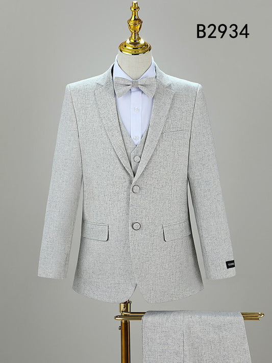 A light gray BOY SUIT 5-PC SET B2934 by Unique Design Menswear is displayed on a mannequin with a bow tie, matching fabric draped over a stand, and model number B2934 shown in the top right corner.