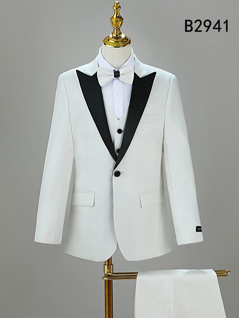 BOY SUIT 5-PC SET B2941 by Unique Design Menswear features a white tuxedo with black lapels, matching vest, bow tie, and trousers on a hanger. Ideal for boys’ formal wear. "B2941" is shown in the top right corner.