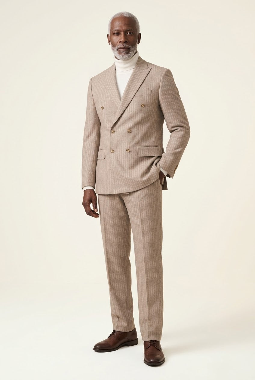 A man wears the Inserch Wool Blend Flannel DB Stripe Suit SU660280-00015 Stone with a white turtleneck and brown dress shoes against a plain light background.