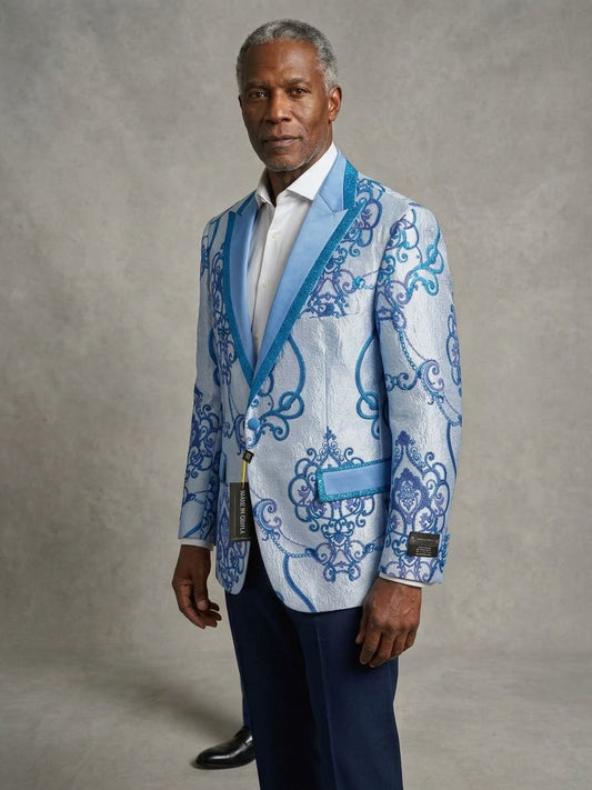 Man standing in a studio wearing EJ SAMUEL JACKET 6 (L, 5XL Only), blue pants, and a white shirt; tags attached—final sale, no returns; plain gray background.