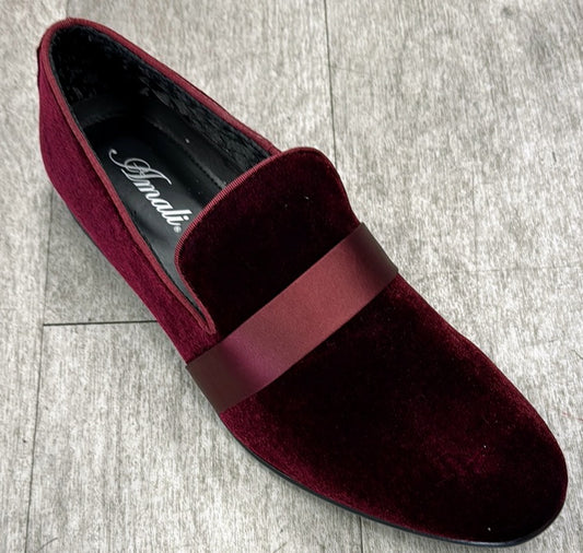 The Exclusive Formal Dress Shoe Burgundy 7021 by UNIQUE DESIGN MENSWEAR, crafted from genuine leather and featuring a matching band, rests elegantly on a light wooden floor.