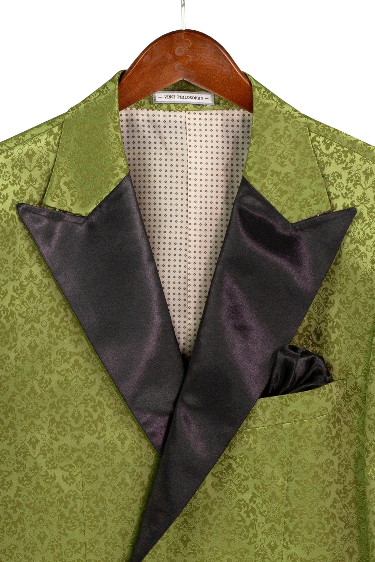 Regular Fit Pesto Floral Jacquard Peak Lapel Blazer BF-9 by Vinci Suits with black satin lapels, black pants, white shirt, green bow tie; boutonniere on left lapel, right hand inside jacket.