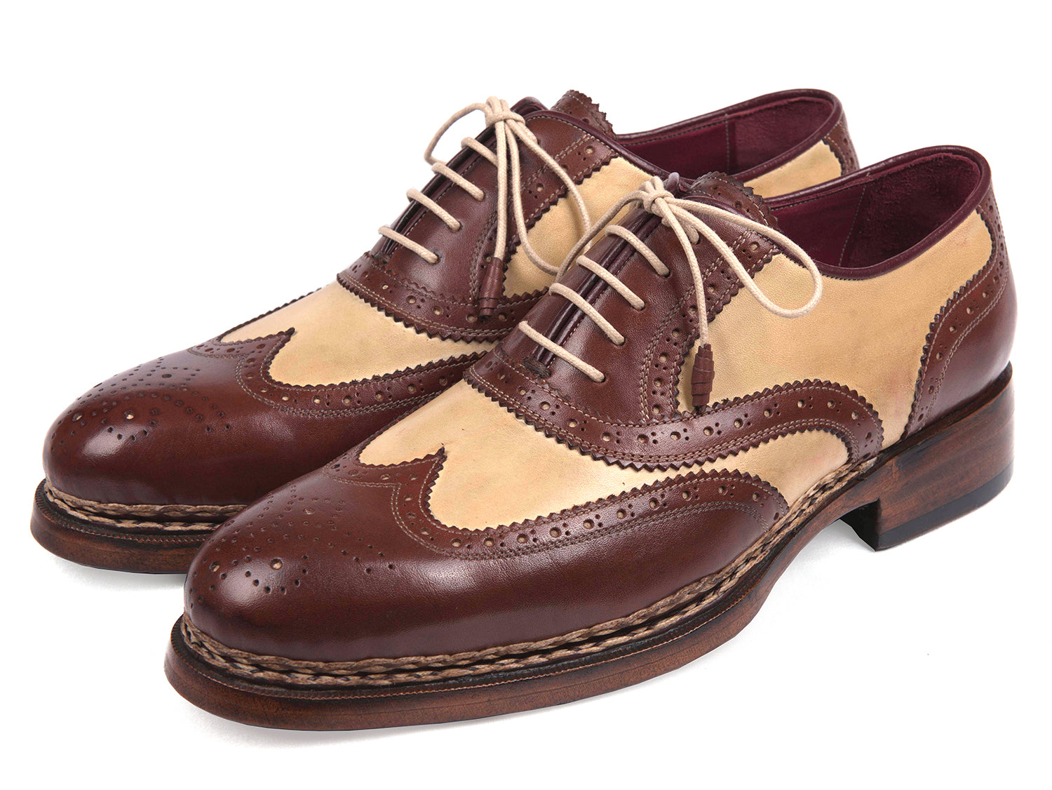 The Paul Parkman Triple Leather Sole Goodyear Welted Wingtip Brogues - 095BEJ are dual-tone brown and beige calfskin shoes with lace-up closures, decorative perforations, and classic brogue detailing.