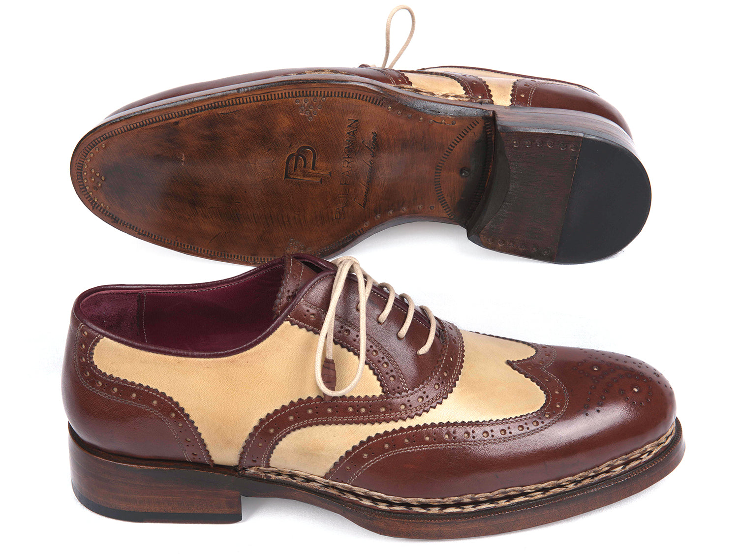The Paul Parkman Triple Leather Sole Goodyear Welted Wingtip Brogues - 095BEJ are dual-tone brown and beige calfskin shoes with lace-up closures, decorative perforations, and classic brogue detailing.