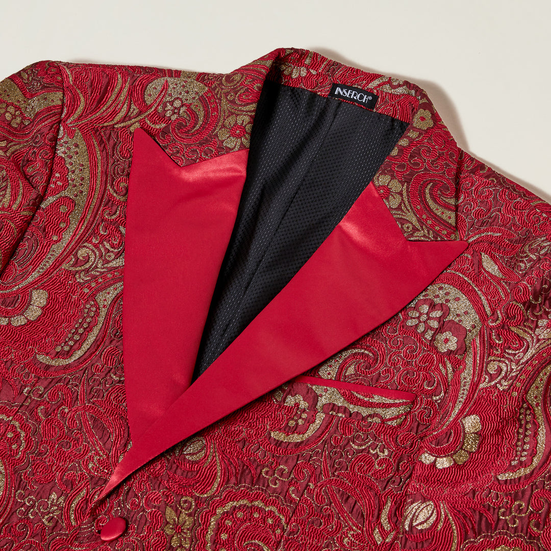 The Inserch Paisley Jacquard Blazer BL205-30 Red features a red paisley pattern with gold accents, red satin lapels, two buttons, three front pockets, and a slim fit. The blazer is shown laid flat on a white background.