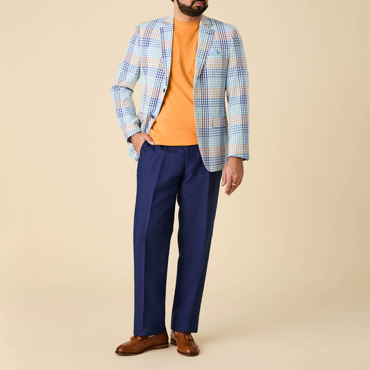 A man wears the Inserch Cotton Seersucker Check Blazer BL262-00066 Multi with an orange sweater, blue trousers, and brown dress shoes against a beige background. His head is not visible in the image. Brand: Inserch.
