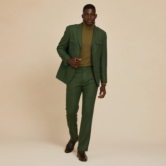 A man in the Inserch Herringbone Suit BL263-19 Olive by Inserch walks toward the camera against a plain beige background.