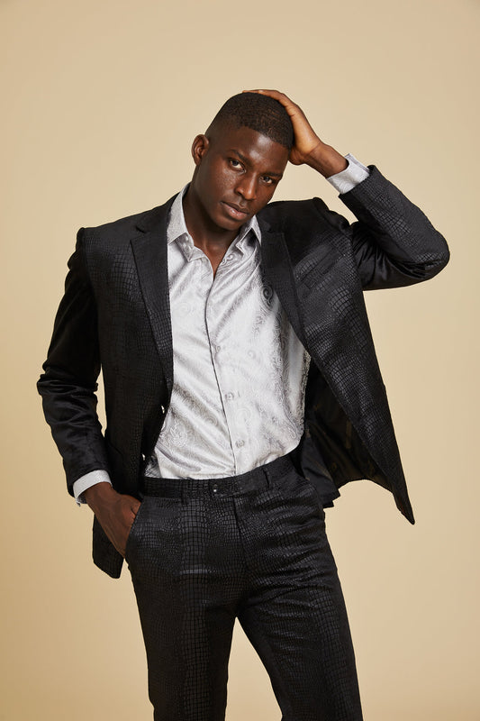 A man models the Inserch Suede Snake Skin Suit BL268-01 Black by Inserch, featuring a modern fit with an embossed snake pattern, styled with a light patterned shirt against a beige background.