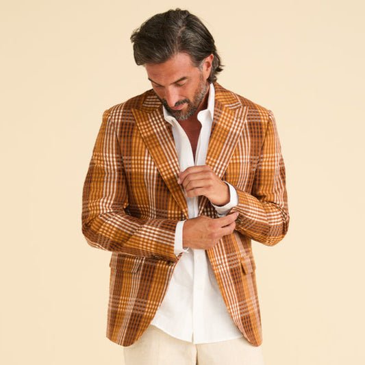 A model wearing the Inserch Seersucker Gingham Blazer BL272-00027 Aztec by Inserch and a white shirt stands against a plain beige background, with the blazer buttoned twice, highlighting its sleek design.