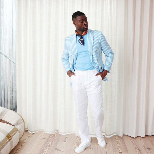A man wearing the Inserch Seersucker Wide Stripe Blazer BL507-00183 Blue Mist with a white shirt stands against a plain beige background.