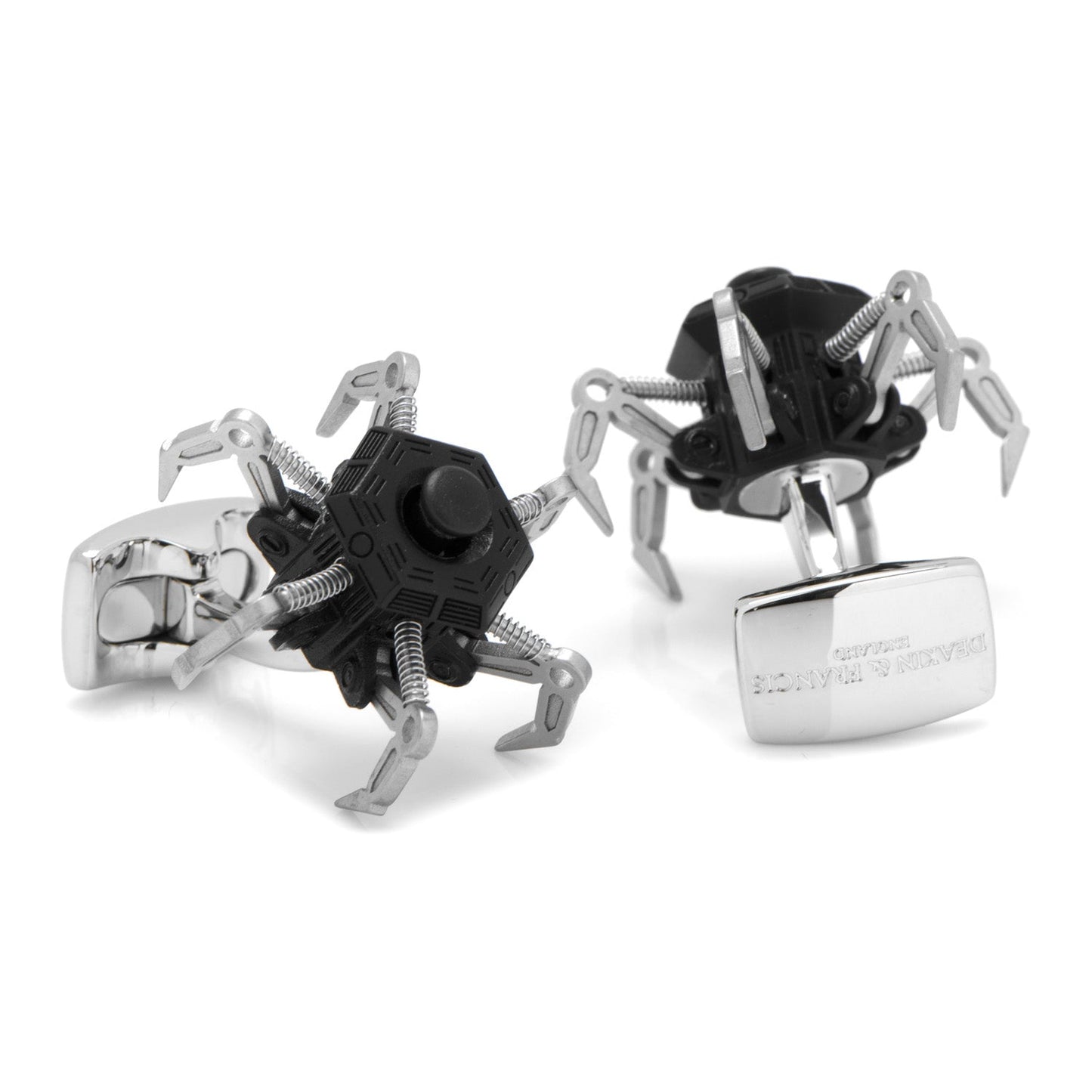 The Drone Cufflinks by Cufflinks.com are designed to resemble small black and silver spider robots with multiple claw-like legs.