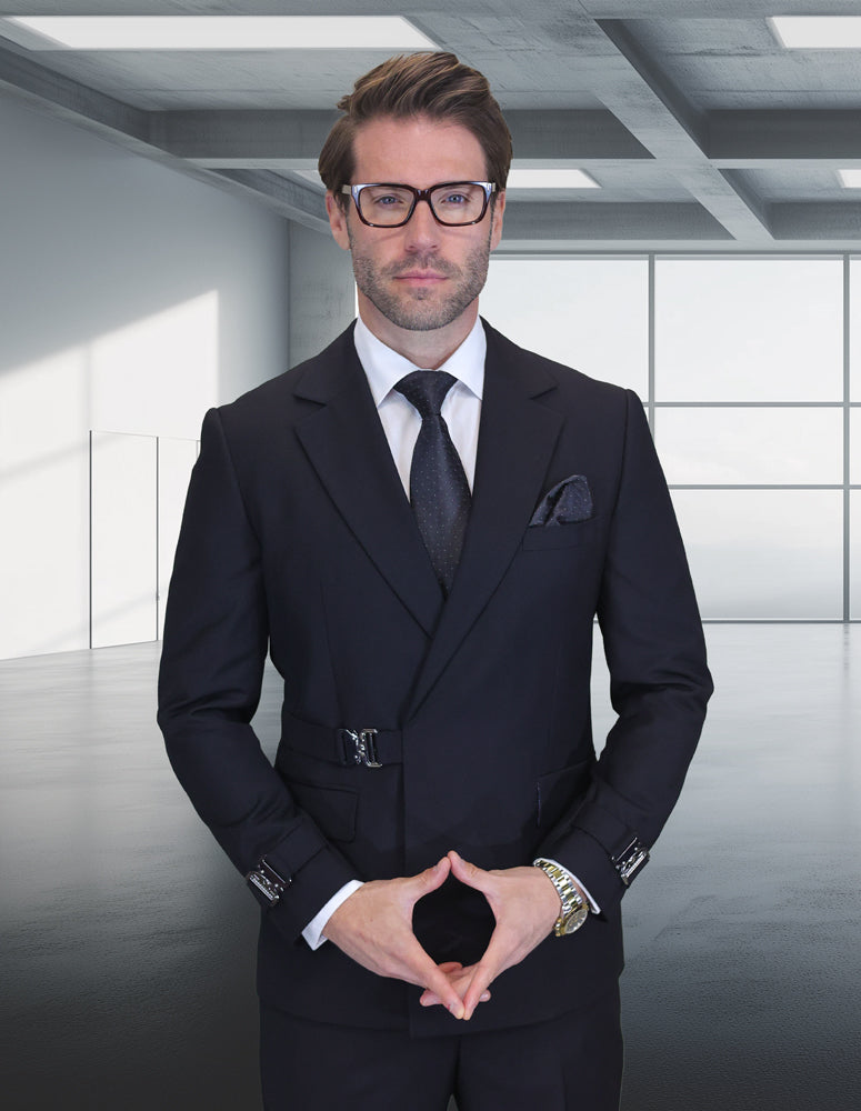 A man in the STATEMENT CLOTHING | BOLANZO-BLACK modern fit double-breasted suit and glasses stands in a minimalist office with large windows and geometric ceiling panels.