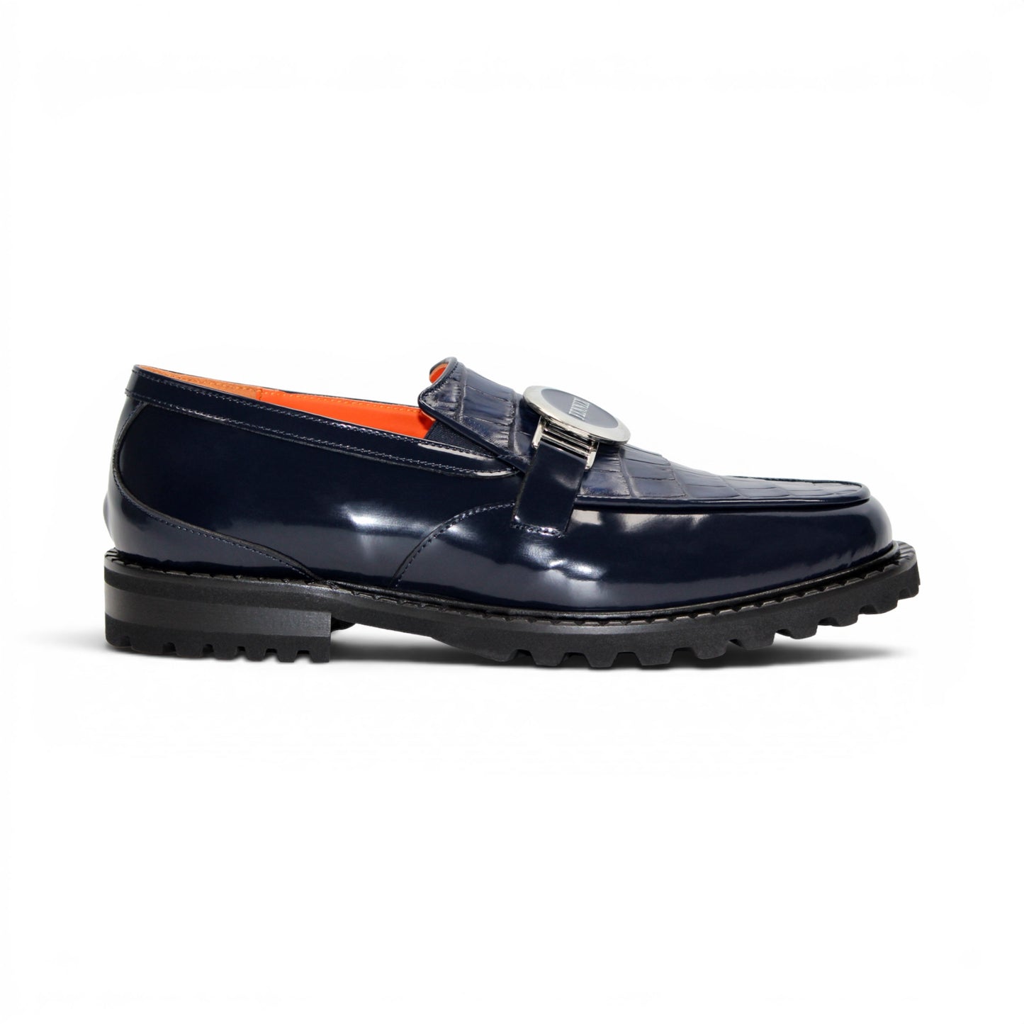 Introducing the Fennix Brant Navy from Fennix of Italy—a sleek navy blue loafer featuring a chunky black sole, vibrant orange inner lining, and a silver buckle accent across the upper strap. Expertly crafted in Italy, this shoe blends contemporary flair with classic elegance.