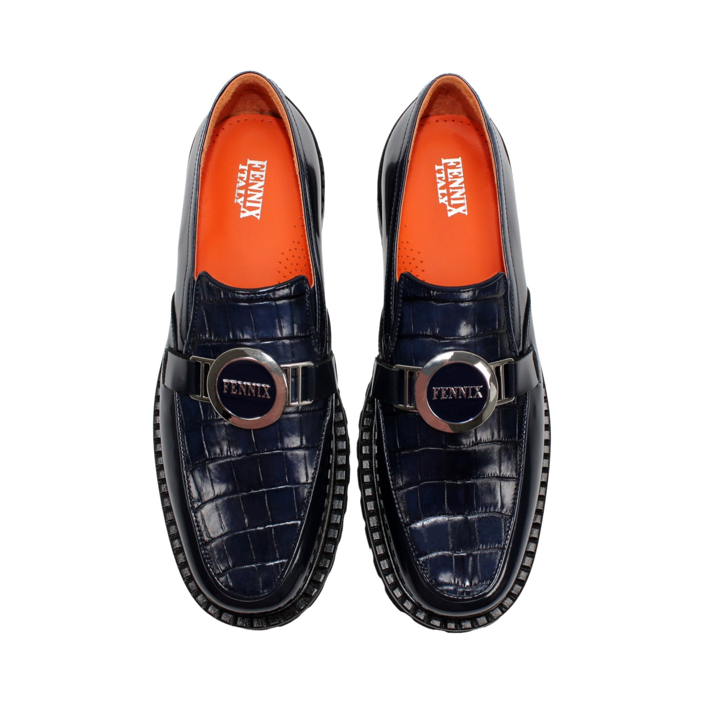 Introducing the Fennix Brant Navy from Fennix of Italy—a sleek navy blue loafer featuring a chunky black sole, vibrant orange inner lining, and a silver buckle accent across the upper strap. Expertly crafted in Italy, this shoe blends contemporary flair with classic elegance.