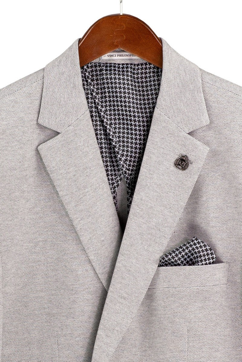 A mannequin showcases the Regular Fit Light Gray Super Stretch Blazer BRK-4 by Vinci Suits with dark gray pants, green shirt, black tie, and green pocket square for comfort and style.