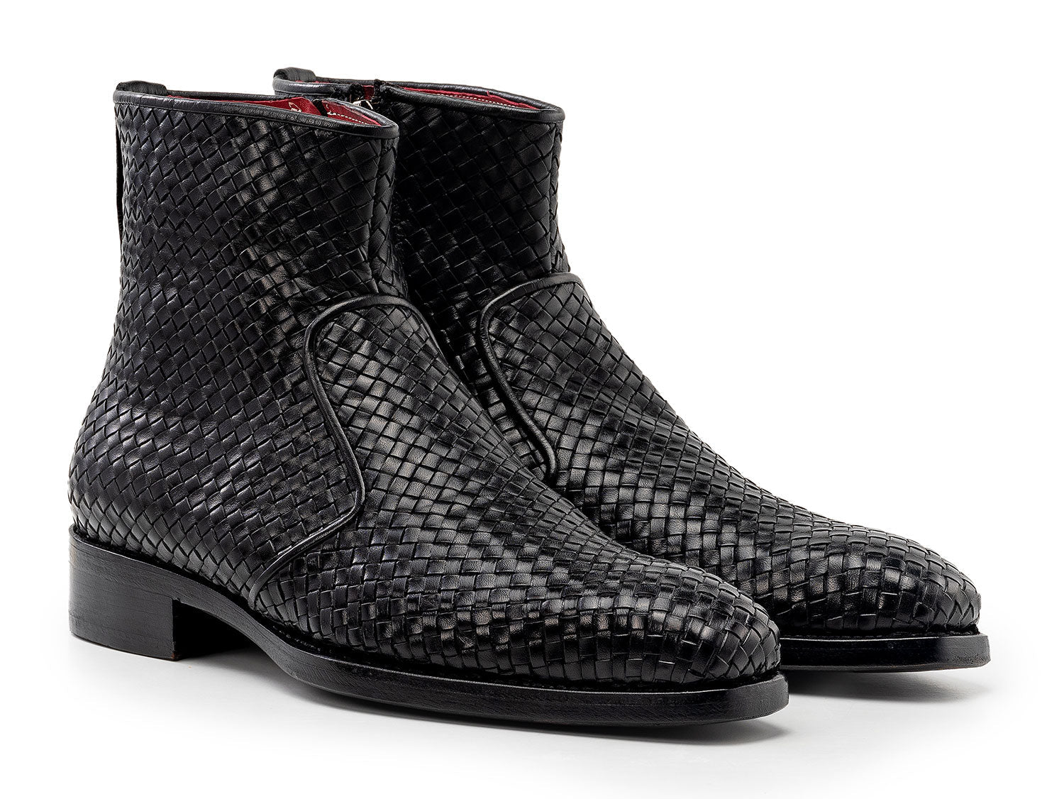 The Paul Parkman Black Woven Leather Goodyear Welted Zipper Boots (BT269BLK) for men are shown on a white background, one upright and the other resting against it.