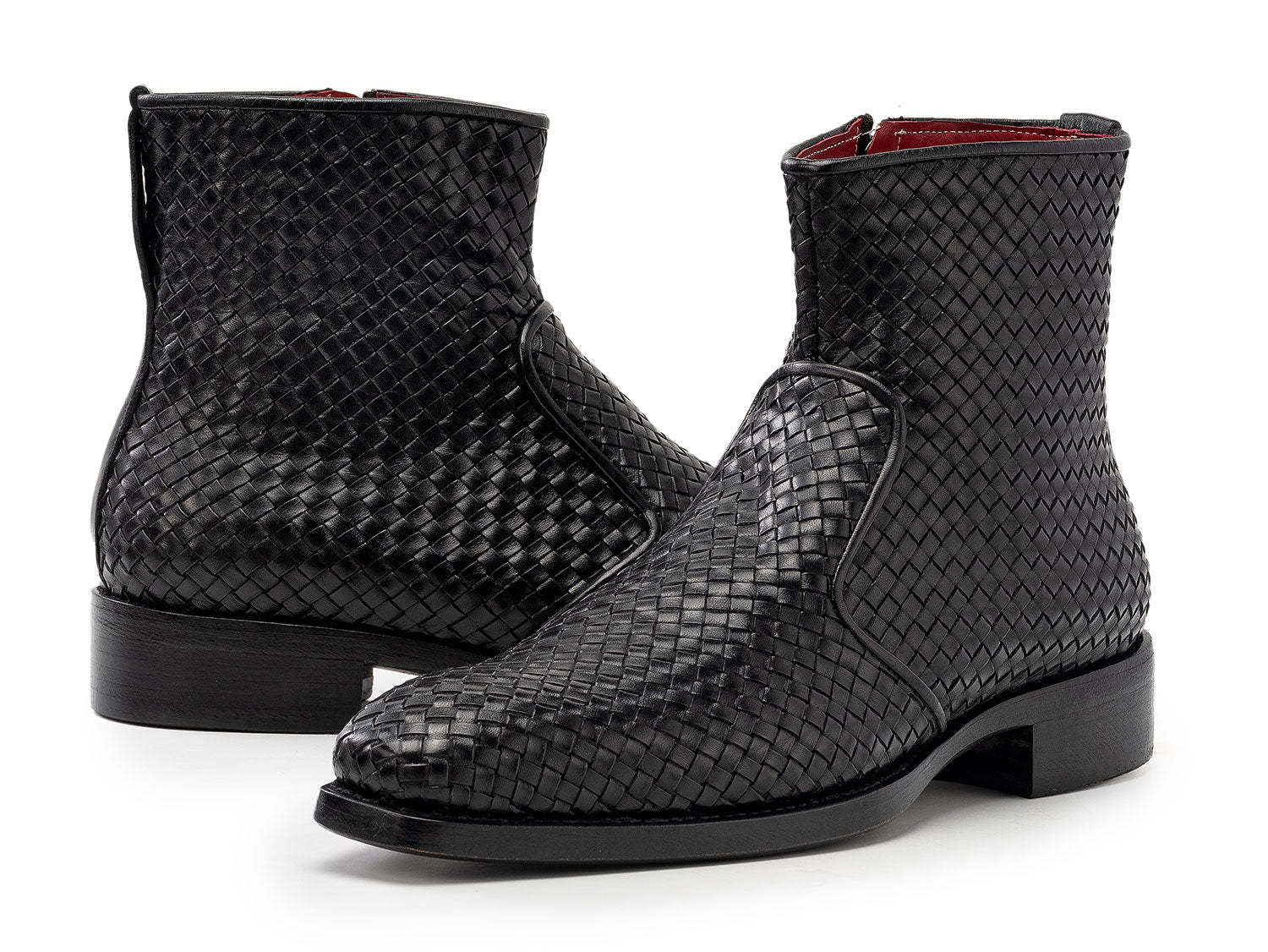 The Paul Parkman Black Woven Leather Goodyear Welted Zipper Boots (BT269BLK) for men are shown on a white background, one upright and the other resting against it.