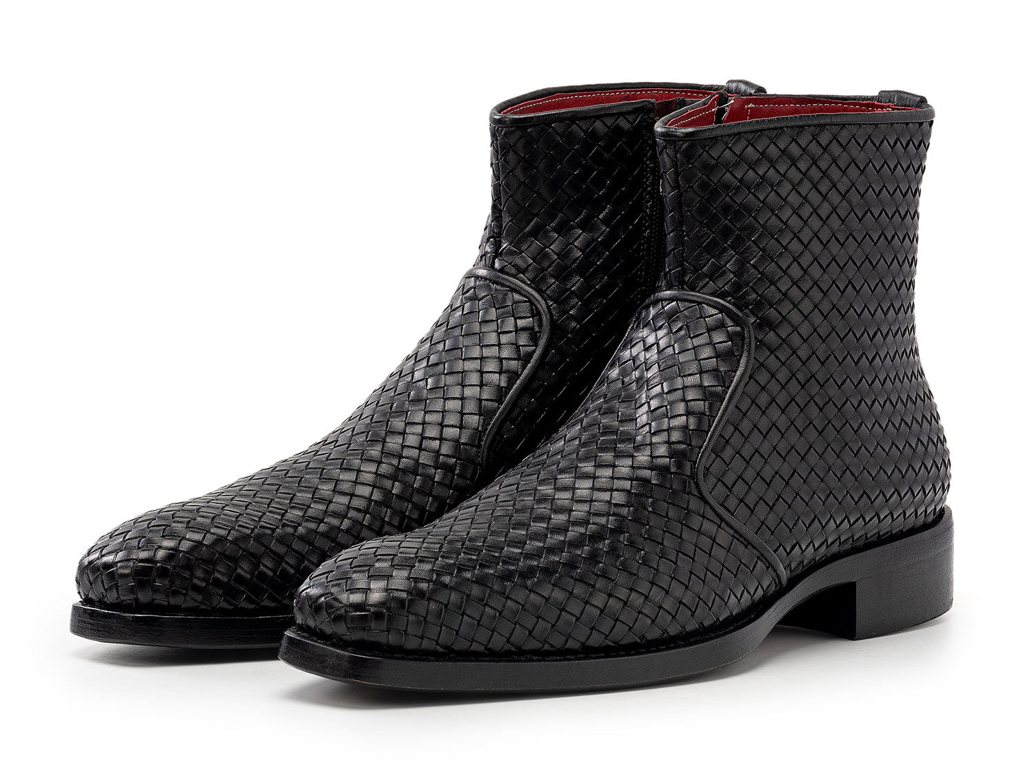 The Paul Parkman Black Woven Leather Goodyear Welted Zipper Boots (BT269BLK) for men are shown on a white background, one upright and the other resting against it.