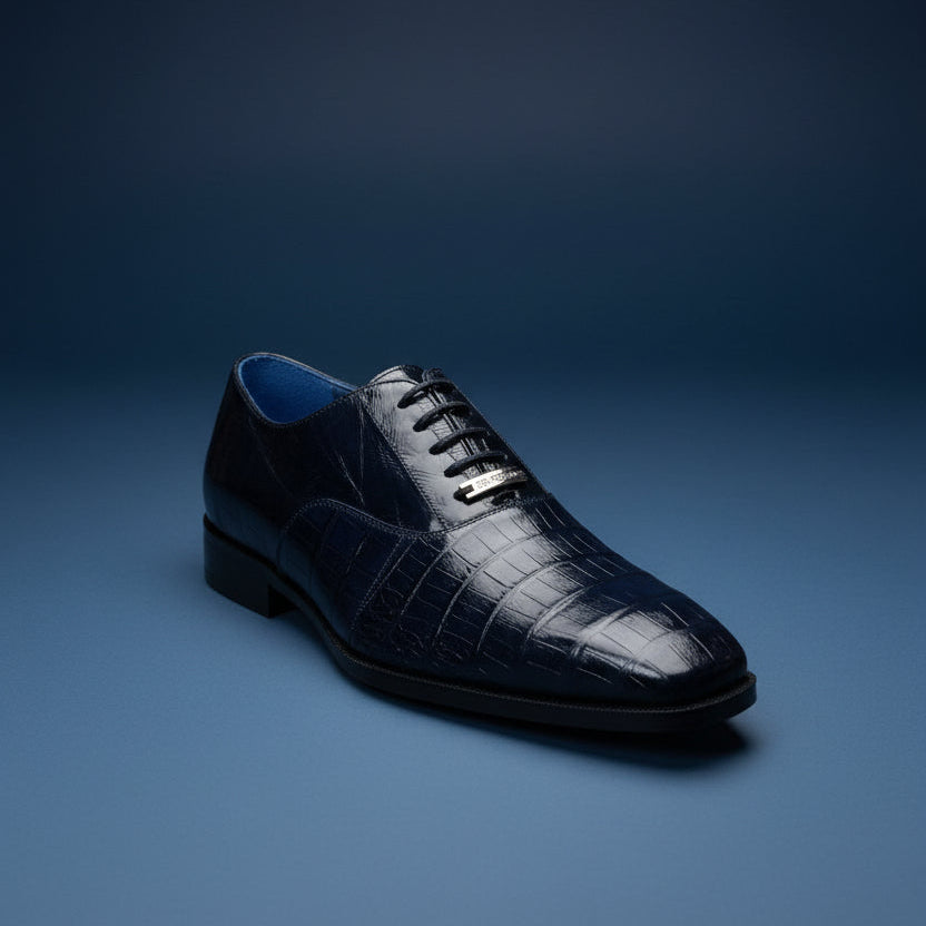 A Belvedere Shoe 8 in black, featuring a crocodile-patterned leather design with laces, is displayed on a wooden surface. Please note: this BELVEDERE shoe is clearance (Size 9 only) and is FINAL SALE—no returns or exchanges will be accepted.