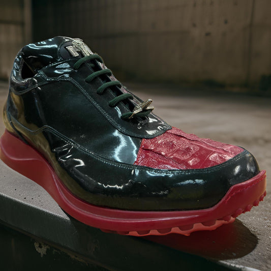 The Mauri 8900 shoes in black and red patent leather showcase a mixed texture design with a red sole and lace-up closure, artfully displayed on a concrete surface.