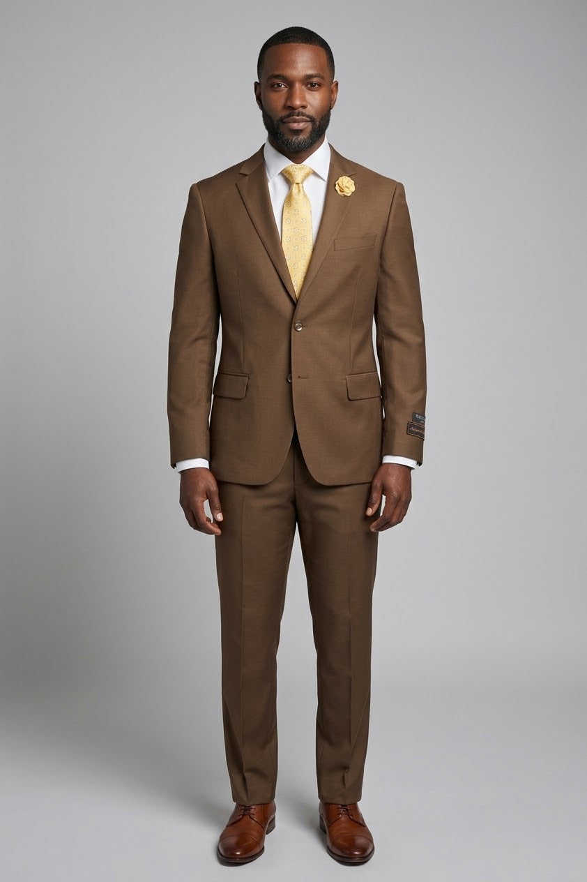 Displayed on a mannequin, the Tiglio Luxe Novello Tobacco Suit, crafted from Italian wool, is paired with a yellow patterned tie and matching lapel flower. This ensemble exemplifies the modern European fit that Tiglio suits are renowned for.
