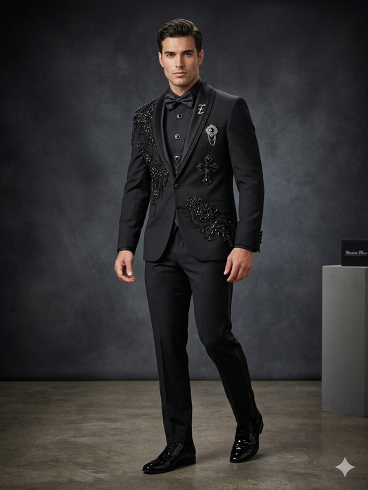 A man wearing the Unique Design Menswear custom prom suit in black and silver stands in a studio with a dark background.