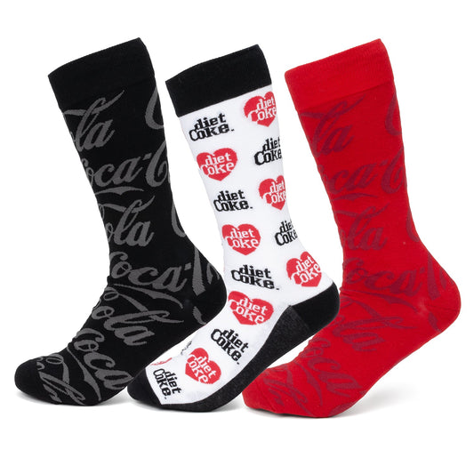 The Coca-Cola 3 Pack Sock Set by Cufflinks.com features three pairs: black with a gray logo, white with Diet Coke branding, and red with the classic Coca-Cola logo.