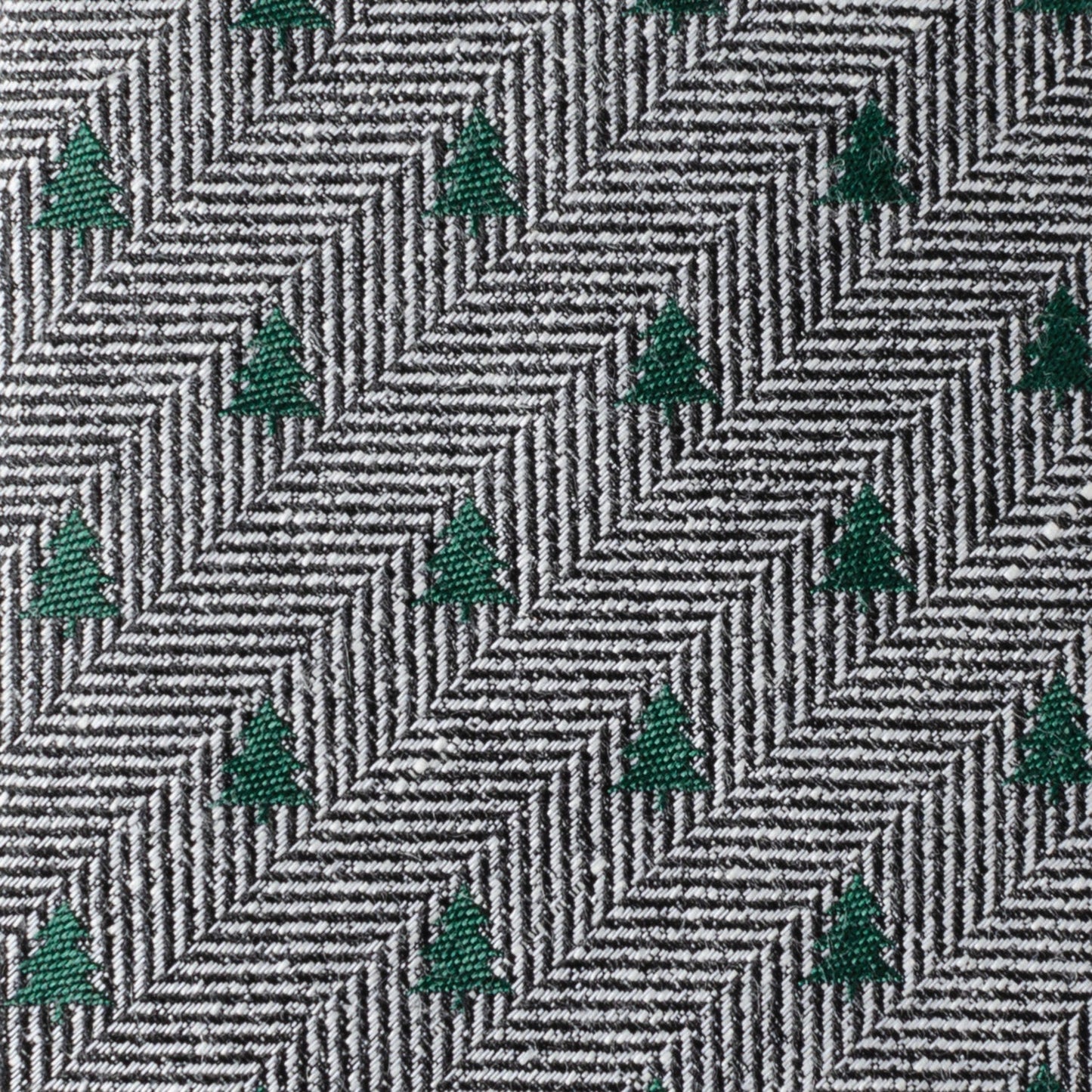 The Holiday Tree Herringbone Tie by Cufflinks.com features a black and white herringbone pattern adorned with small green tree motifs for a subtle, stylish look.