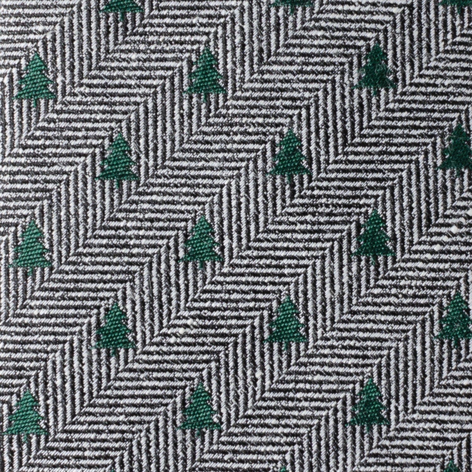 The Holiday Tree Herringbone Tie by Cufflinks.com features a black and white herringbone pattern adorned with small green tree motifs for a subtle, stylish look.