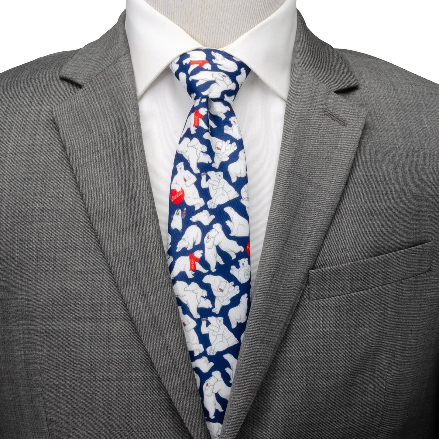 The Coca-Cola Polar Bear Navy Blue Men's Tie by Cufflinks.com features a festive pattern of white polar bears with red and white bottles—an ideal holiday accessory for fans of Coca-Cola.