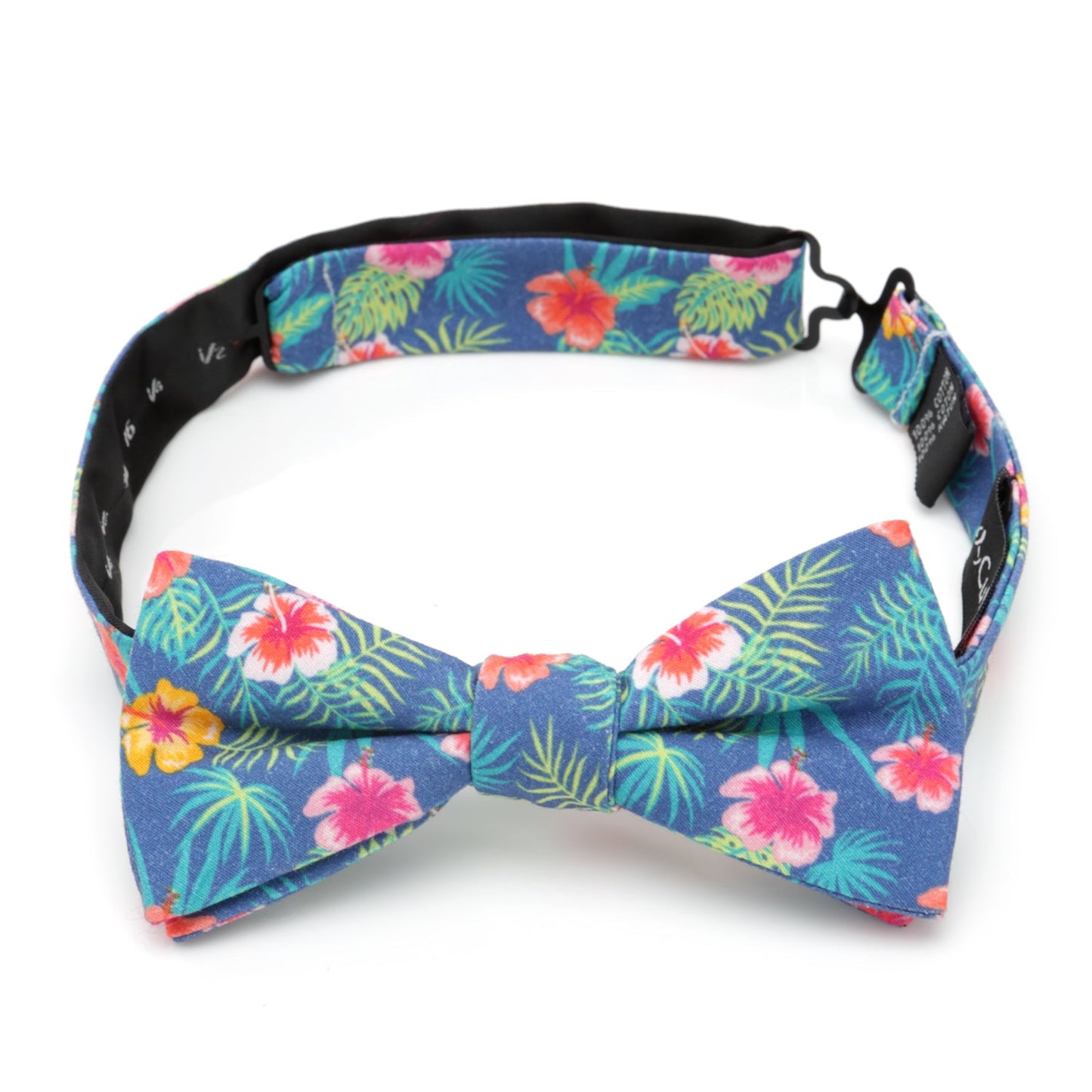 The Tropical Multi Men’s Bow Tie by Cufflinks.com features a colorful floral pattern with pink, yellow, and red flowers, green palm leaves, and vibrant hibiscus accents.