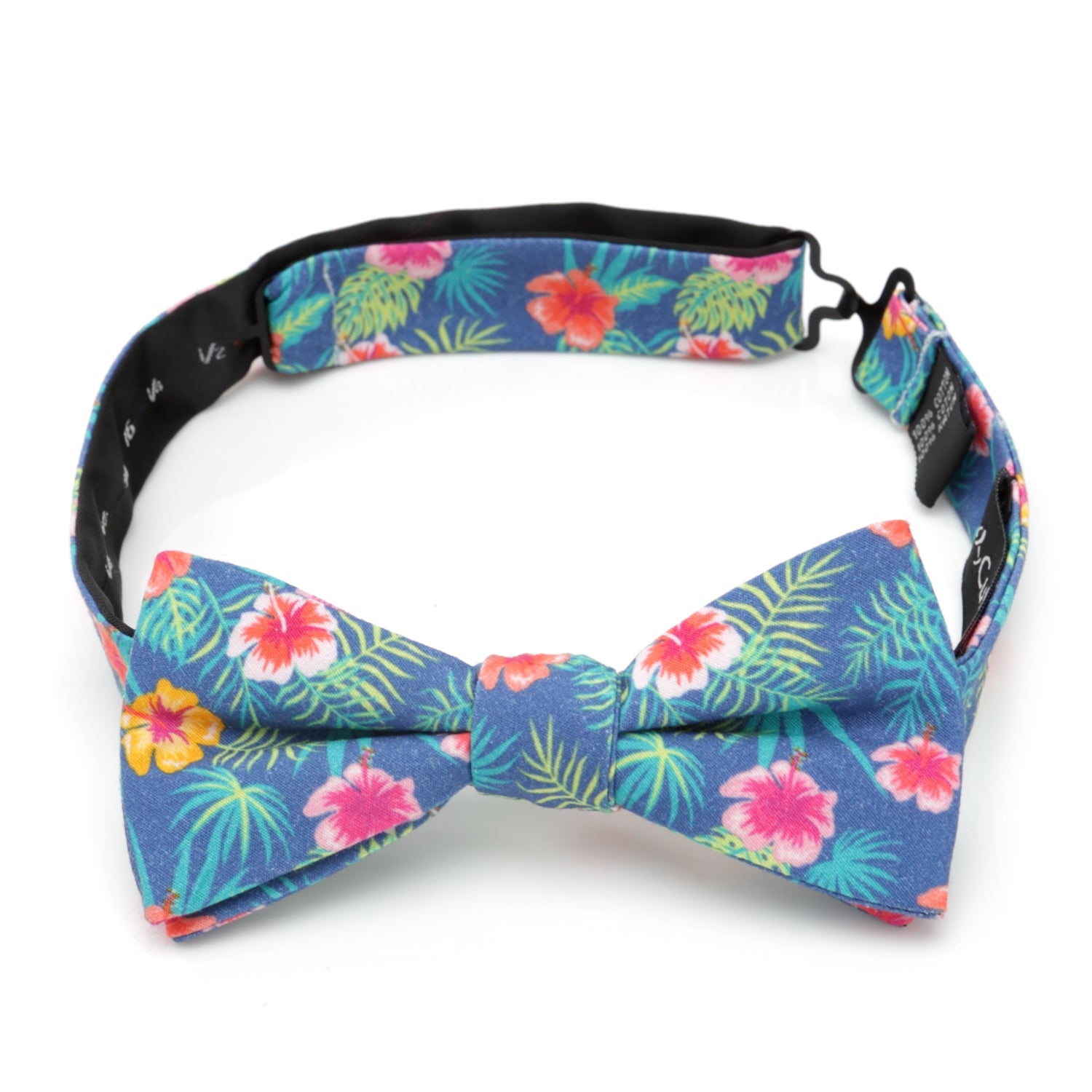 The Tropical Multi Men’s Bow Tie by Cufflinks.com features a colorful floral pattern with pink, yellow, and red flowers, green palm leaves, and vibrant hibiscus accents.