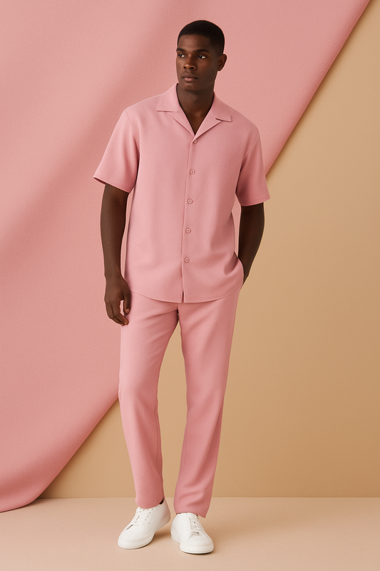 The Inserch 2pc Set (Shirts and Pants) Summer Pink by Inserch is draped diagonally over a beige background, showcasing its pink microfiber-like fabric.