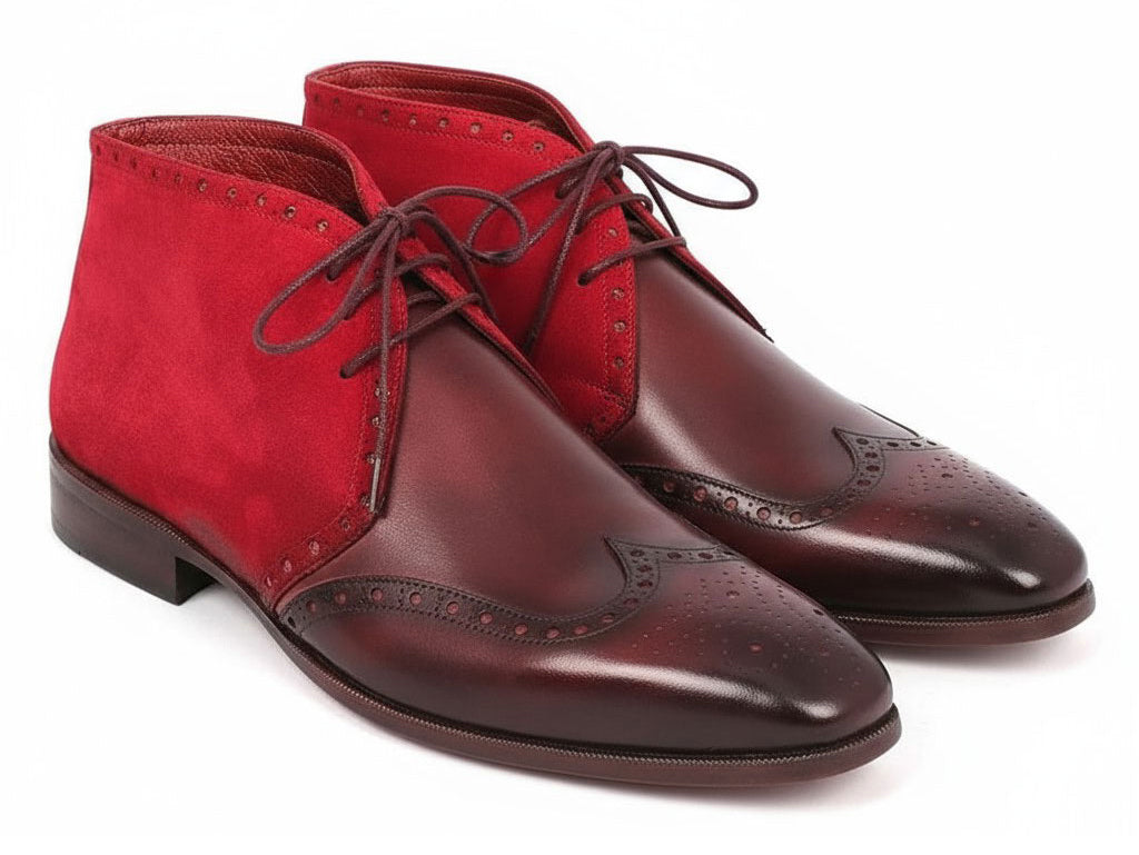 A pair of Paul Parkman Chukka Boots in Bordeaux suede and leather, the CK51-BRD model showcases elegant wingtip design with decorative perforations and dark laces, adding a touch of sophistication.