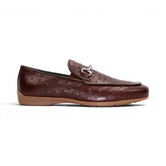 The Duca Di Matiste Duca Cortona Marrone features a luxurious brown leather loafer design with a textured Stampa Struzzo ostrich pattern, an elegant decorative metal bit on the upper, and a tan rubber sole. Displayed on a white background, this shoe exemplifies the finest Italian craftsmanship in men's luxury leather footwear.