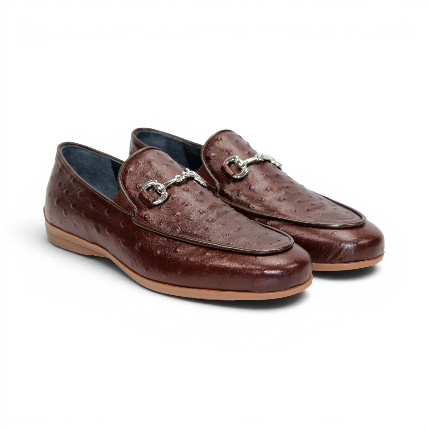 The Duca Di Matiste Duca Cortona Marrone features a luxurious brown leather loafer design with a textured Stampa Struzzo ostrich pattern, an elegant decorative metal bit on the upper, and a tan rubber sole. Displayed on a white background, this shoe exemplifies the finest Italian craftsmanship in men's luxury leather footwear.