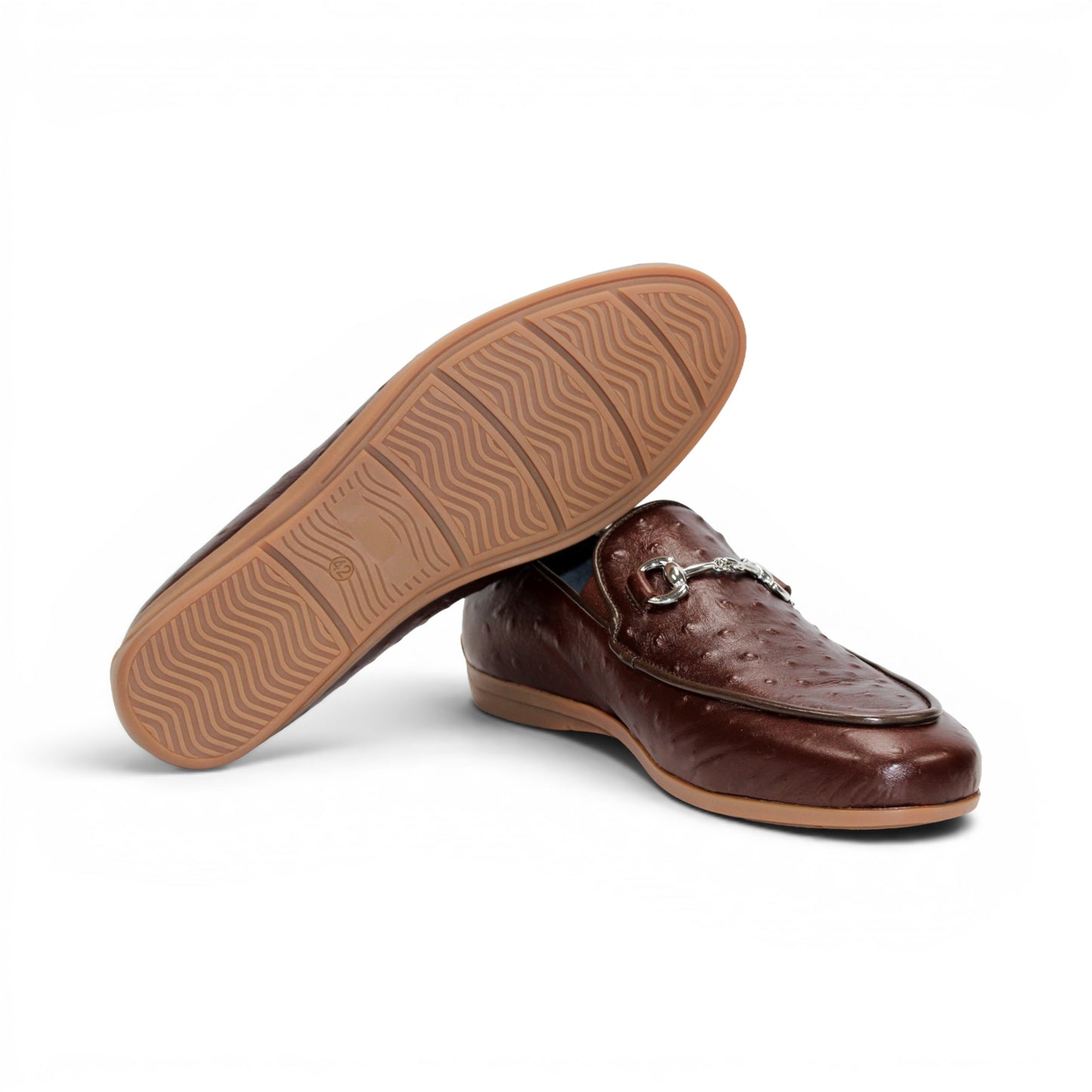 The Duca Di Matiste Duca Cortona Marrone features a luxurious brown leather loafer design with a textured Stampa Struzzo ostrich pattern, an elegant decorative metal bit on the upper, and a tan rubber sole. Displayed on a white background, this shoe exemplifies the finest Italian craftsmanship in men's luxury leather footwear.
