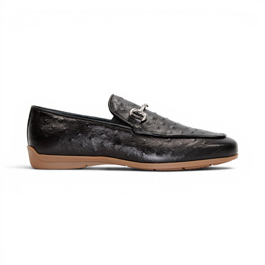 The Duca Cortona Black by Duca Di Matiste is a black Stampa Struzzo leather loafer, crafted in the style of a classic Italian shoe, featuring a silver buckle detail and a light brown rubber sole. Shown in profile on a white background, this refined design is an excellent choice for luxury footwear enthusiasts.