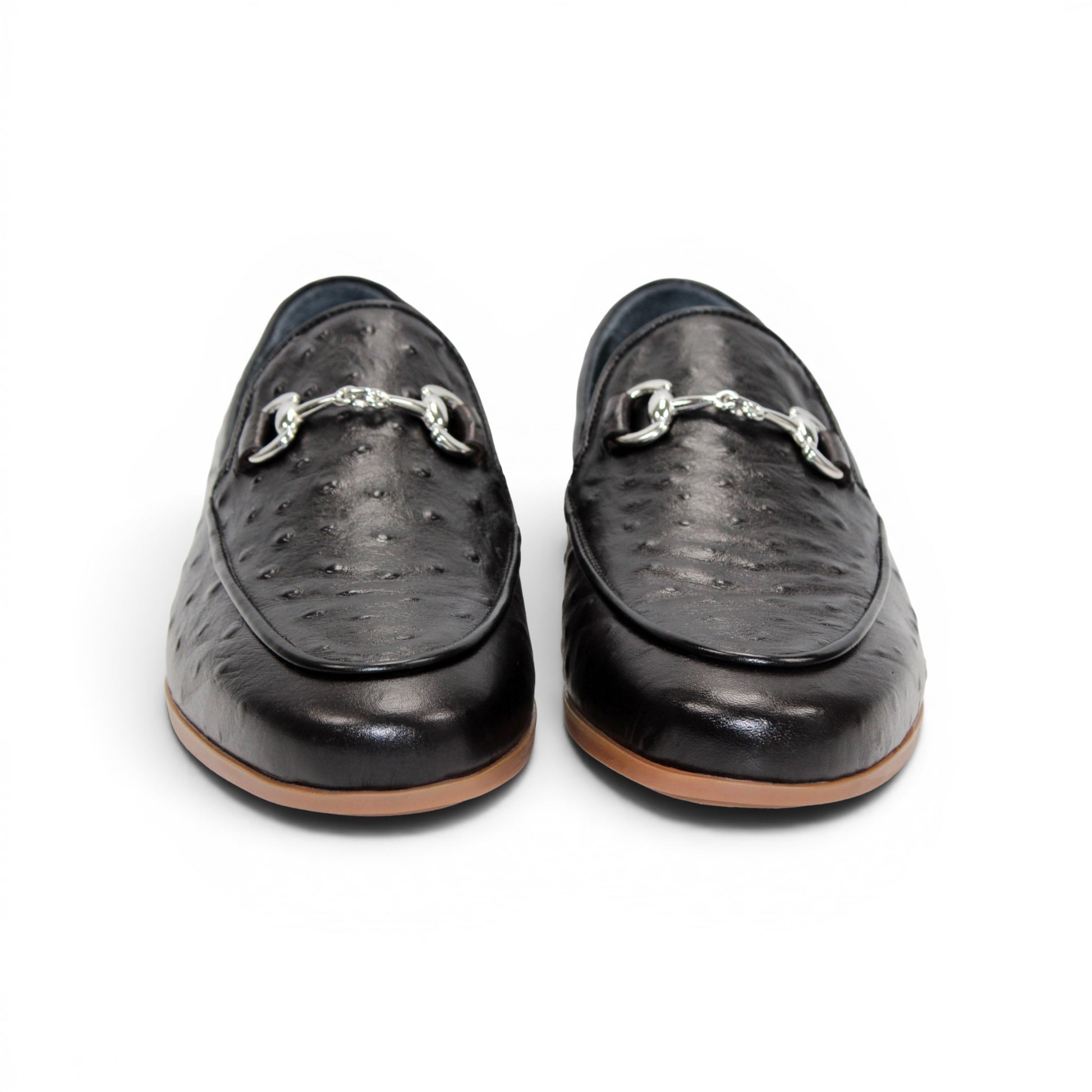 The Duca Cortona Black by Duca Di Matiste is a black Stampa Struzzo leather loafer, crafted in the style of a classic Italian shoe, featuring a silver buckle detail and a light brown rubber sole. Shown in profile on a white background, this refined design is an excellent choice for luxury footwear enthusiasts.