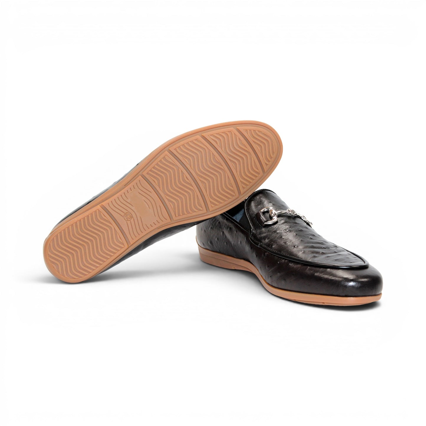 The Duca Cortona Black by Duca Di Matiste is a black Stampa Struzzo leather loafer, crafted in the style of a classic Italian shoe, featuring a silver buckle detail and a light brown rubber sole. Shown in profile on a white background, this refined design is an excellent choice for luxury footwear enthusiasts.
