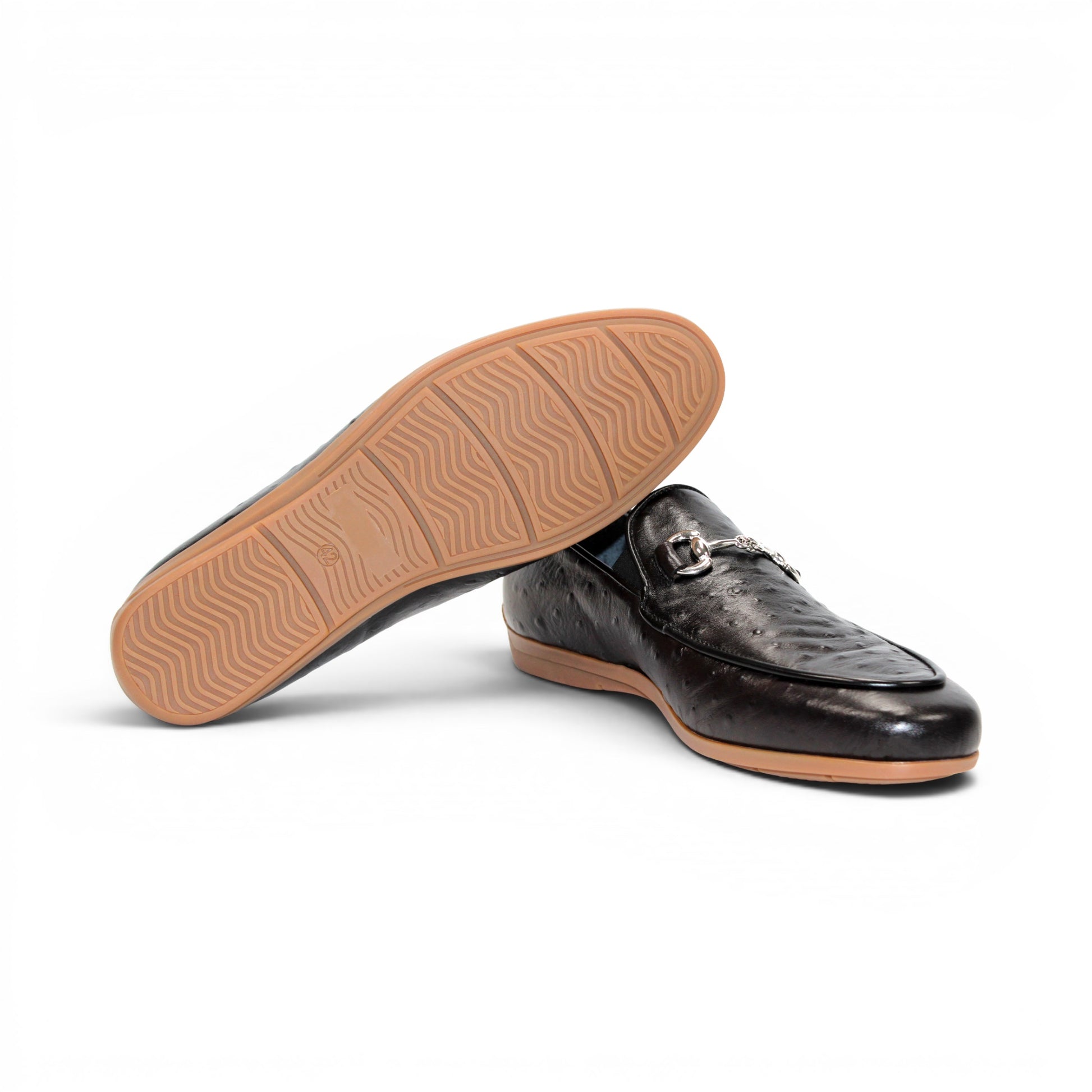 The Duca Cortona Black by Duca Di Matiste is a black Stampa Struzzo leather loafer, crafted in the style of a classic Italian shoe, featuring a silver buckle detail and a light brown rubber sole. Shown in profile on a white background, this refined design is an excellent choice for luxury footwear enthusiasts.