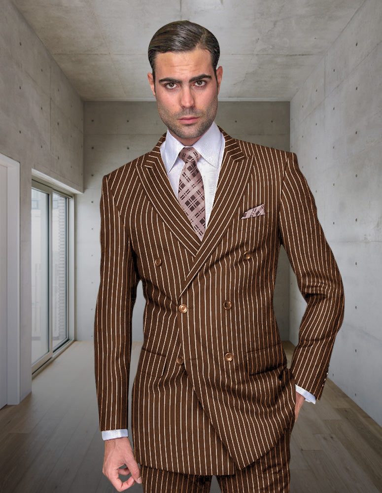 A man wearing the STATEMENT CLOTHING | DB-ZARELLI-BRONZE suit by Statement Clothing stands in a modern, minimalist room with concrete walls and wooden floors.