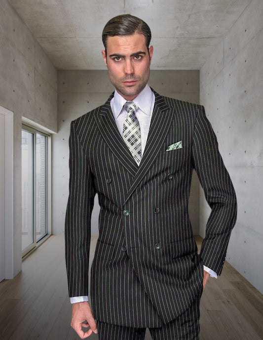A man wearing the STATEMENT CLOTHING | DB-ZARELLI-HUNTER pinstripe double-breasted suit by Statement Clothing stands in a modern, minimalist room with concrete walls and wooden floors, looking directly at the camera.