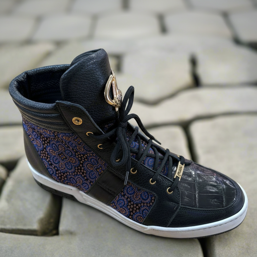 The Mauri 8411 Boots (SIZE 9.5 ONLY) by Mauri feature high-top Italian design, black patent leather, blue and red patterned panels, gold eyelets and emblem on the tongue, and a white sole, shown on stone pavement.