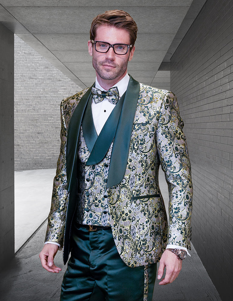 A man in the STATEMENT CLOTHING | DELANO-2-HUNTER modern fit tuxedo by Statement Clothing, featuring ornate patterns and a bow tie, stands in a concrete hallway looking at the camera.