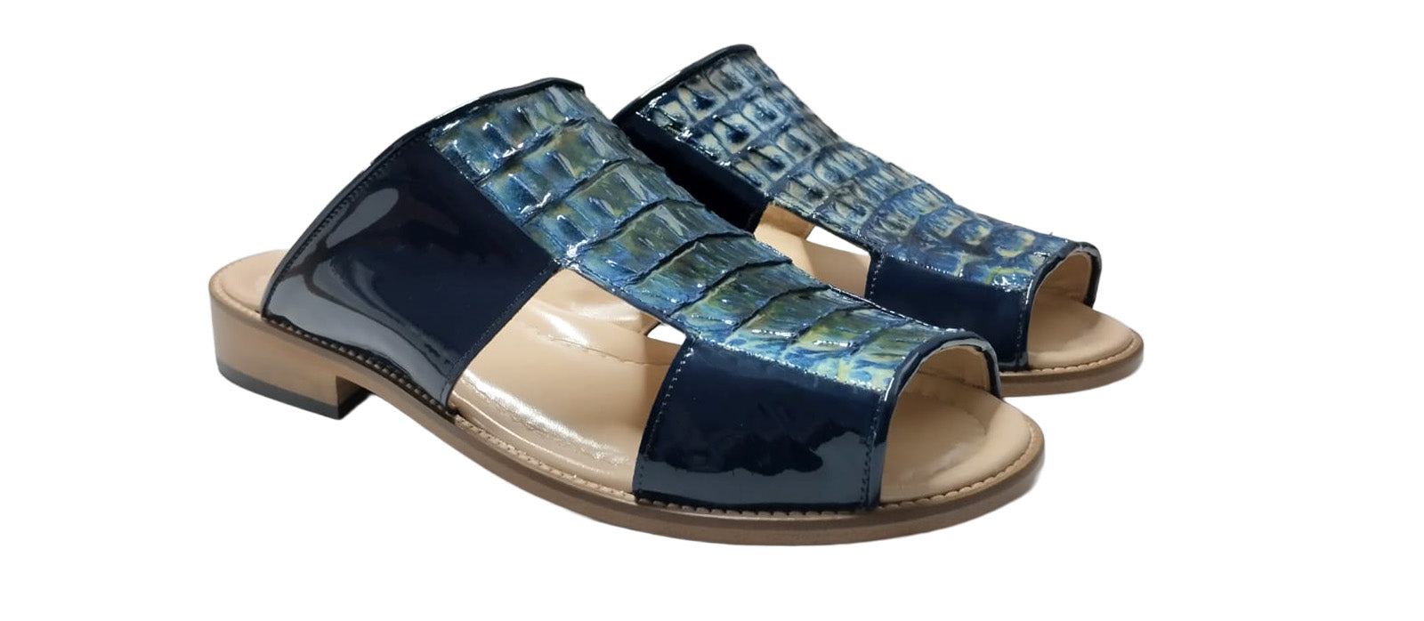 A side view of the Fennix Diego Blue sandal by Fennix of Italy, featuring a wooden sole, black patent leather sides, and a textured blue upper with intricate cut-out detailing—exemplifying the exotic luxury typical of Italian craftsmanship.